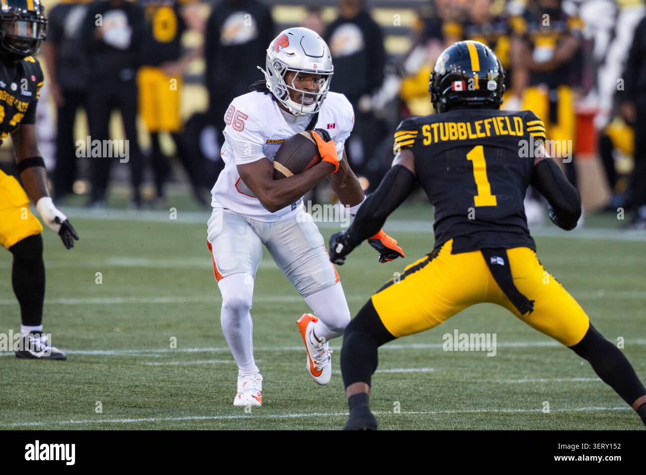 B.C. Lions' Nick Cenacle (85) tries to move the ball past Hamilton ...