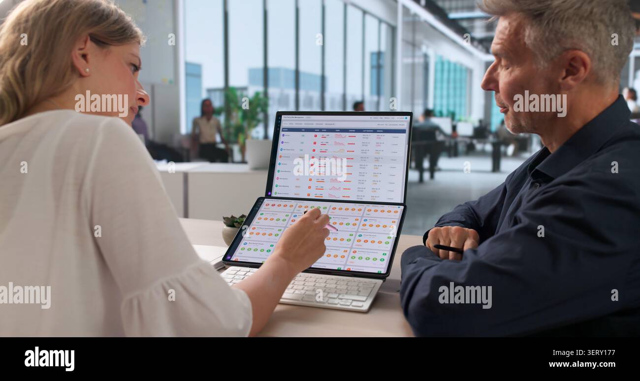 Vendor Risk Manager And Team Analyze Supplier Data Using Software Tools. Stock Photo