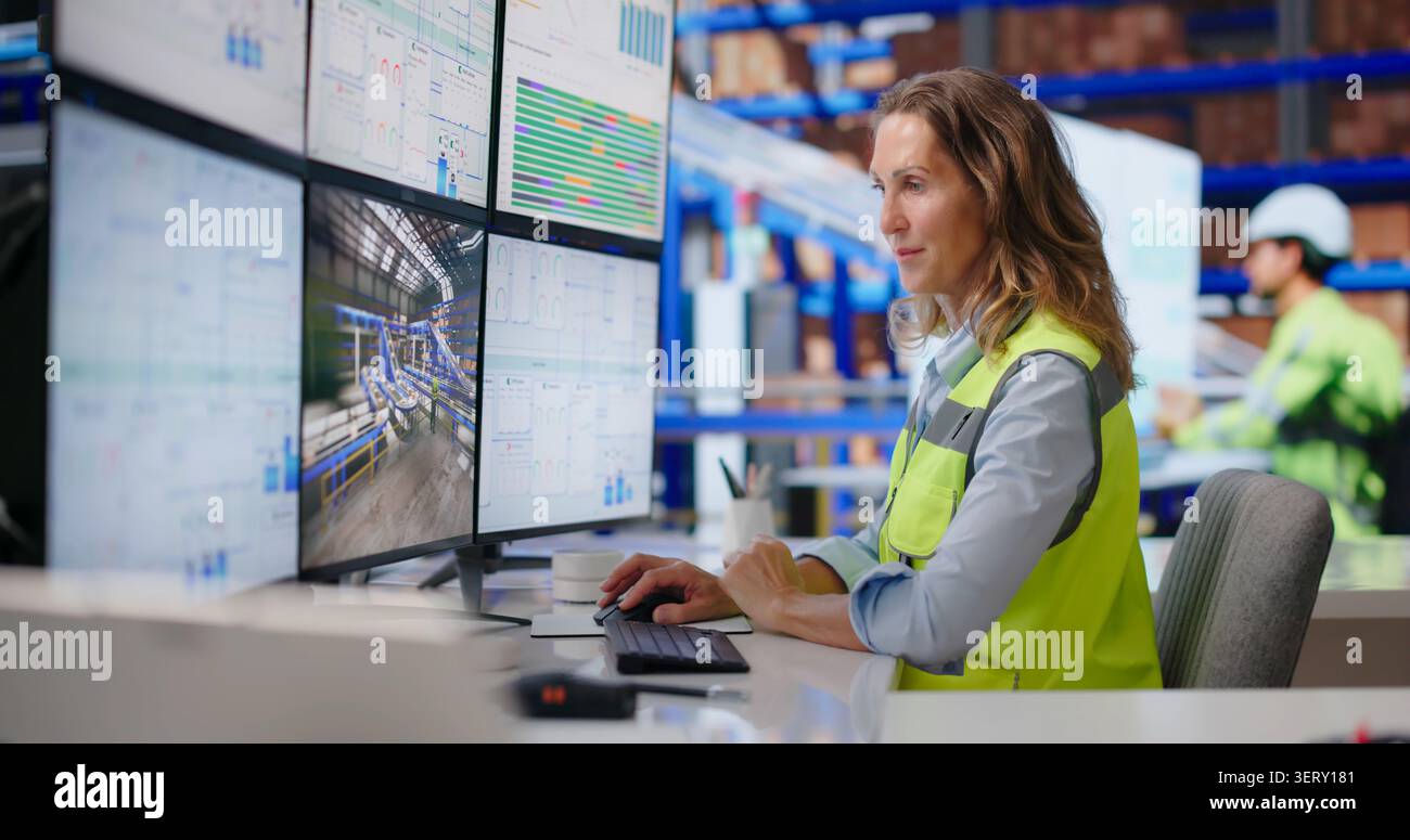 Experienced Logistics Manager Monitors Real-time Package Flow On Multiple Screens Confidently. Stock Photo