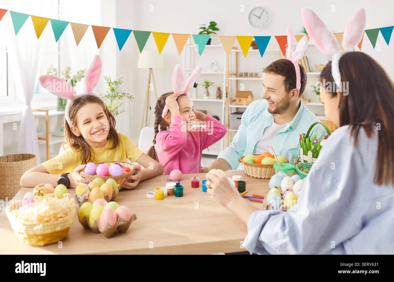 Happy family gather together for decorating Easter eggs Stock Photo