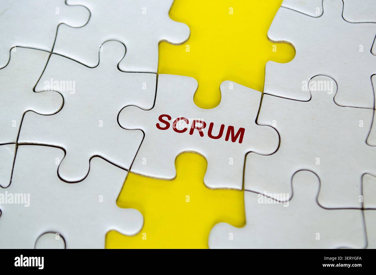 SCRUM text of white jigsaw puzzle represent a framework for collaborative project delivery. Stock Photo