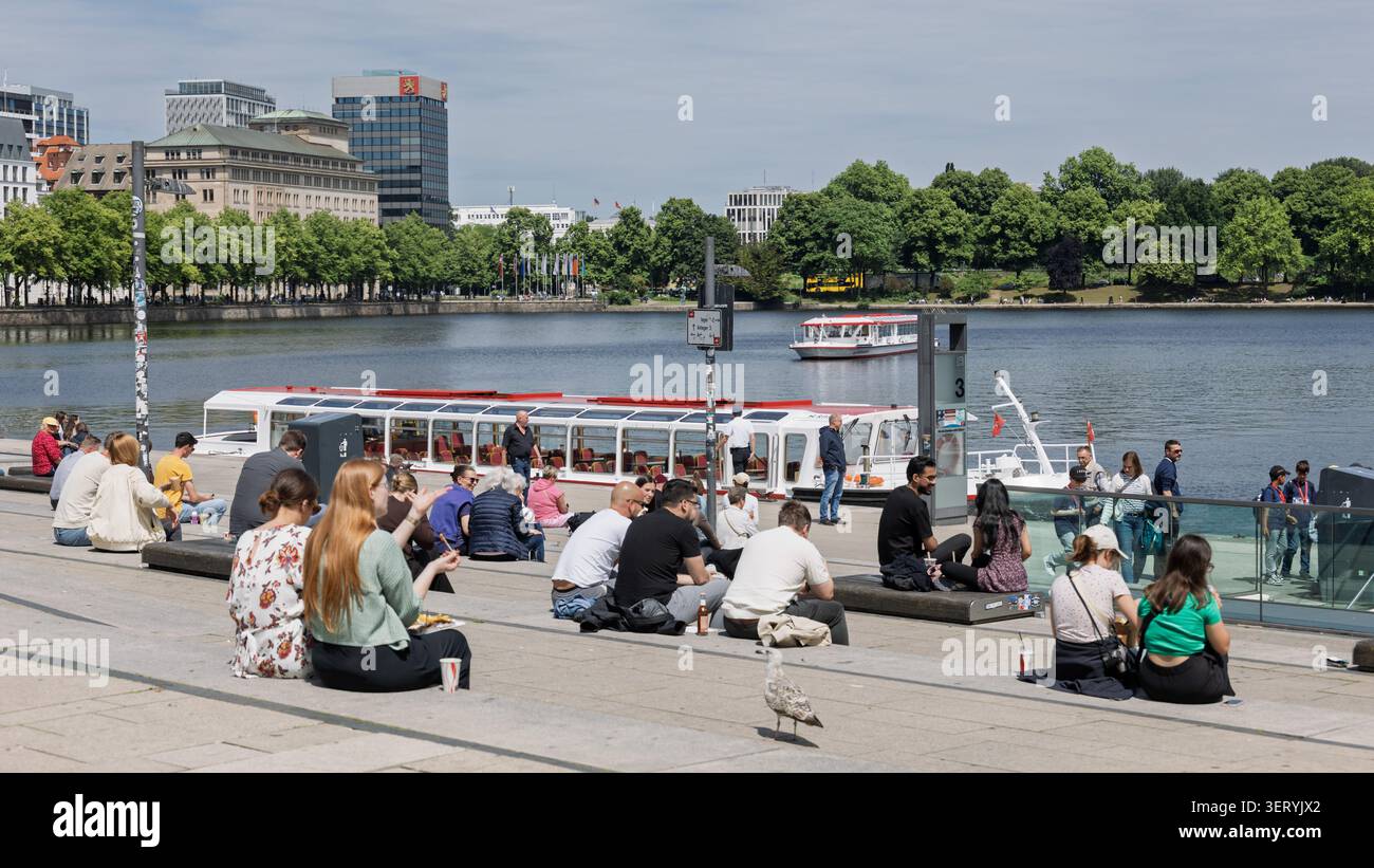 16-june-2026-hamburg-people-are-sitting-at-the-jungfernstieg-pier-on