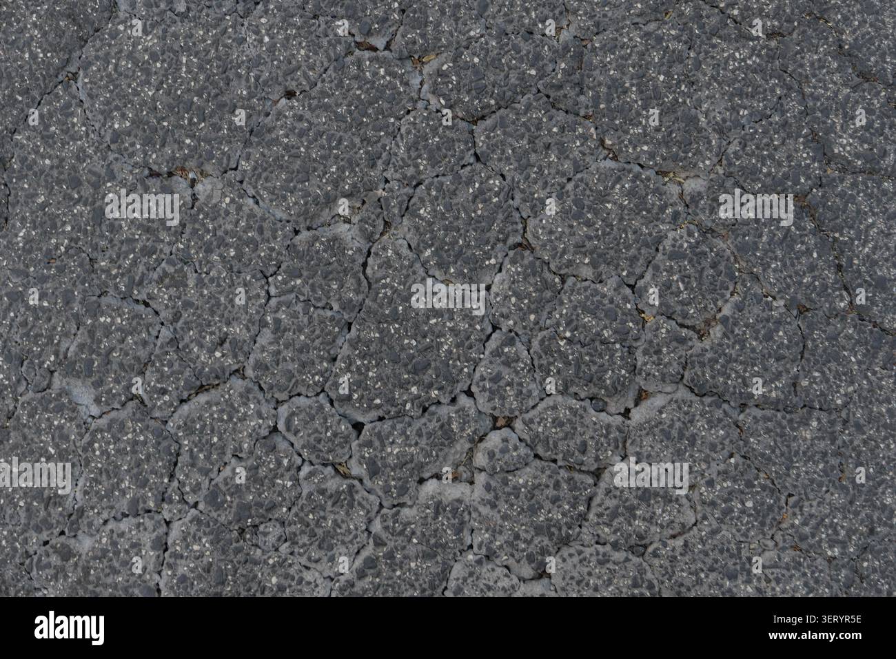 ABSTRACT BACKGROUND TEXTURE OLD CRACKED ASPHALT PAVEMENT Stock Photo