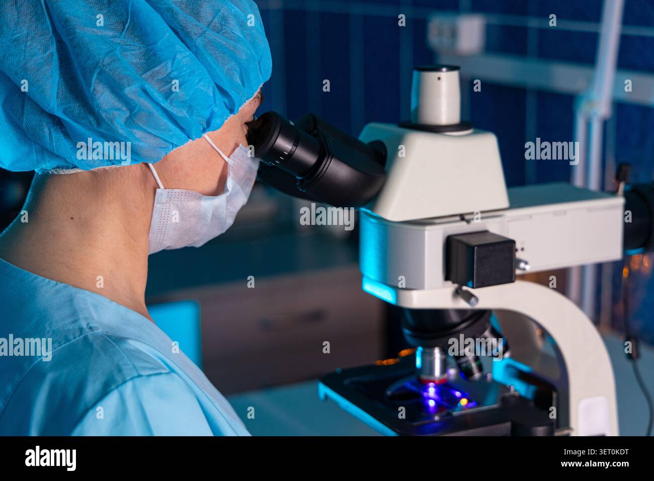 Laboratory Scientist Looking Through Microscope During Medical Research Stock Photo