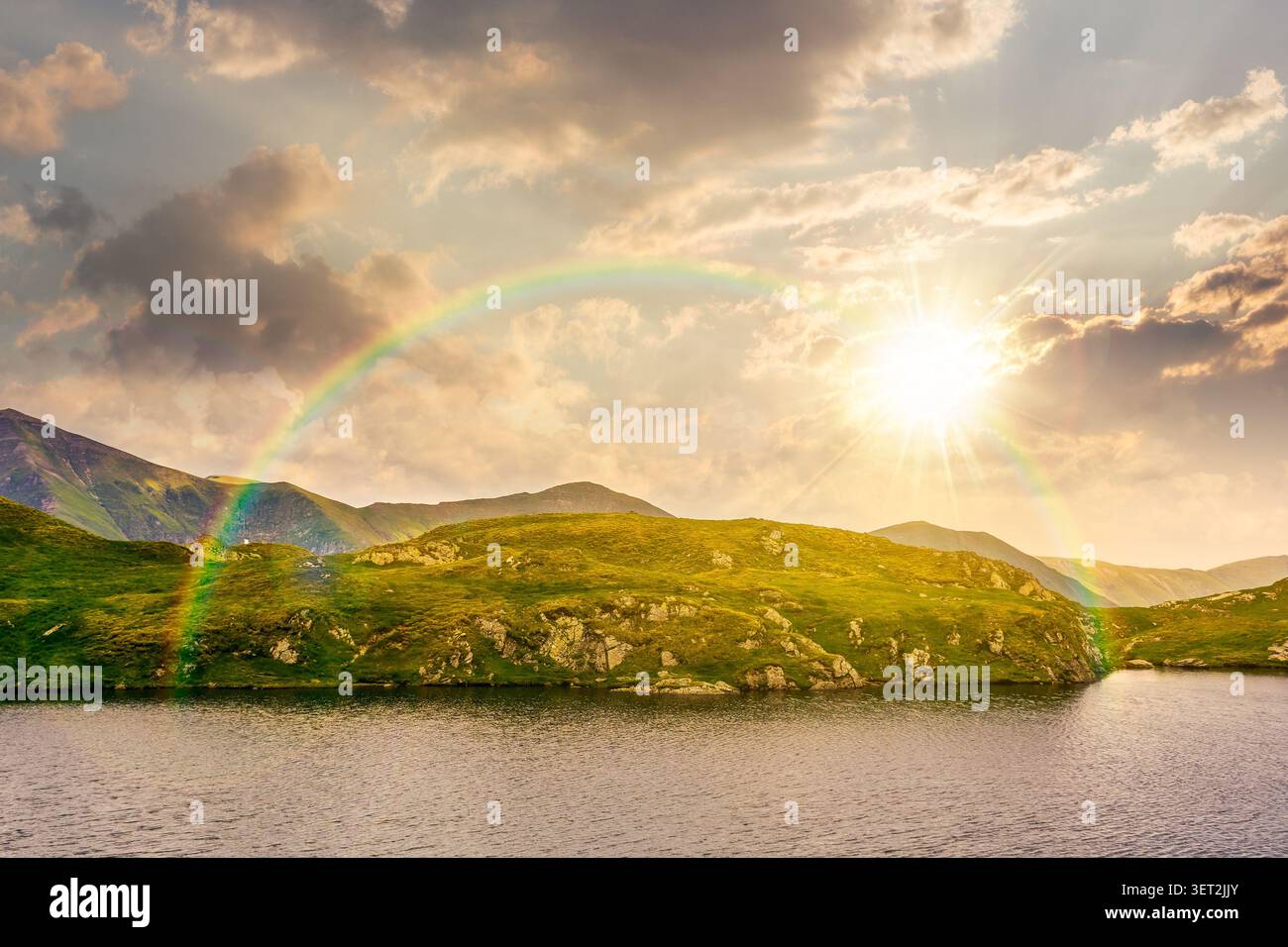 sunset over lovely summer scenery of alpine capra lake with steep slopes. nice view of transylvania alps, sibiu county. southern carpathian mountains Stock Photo