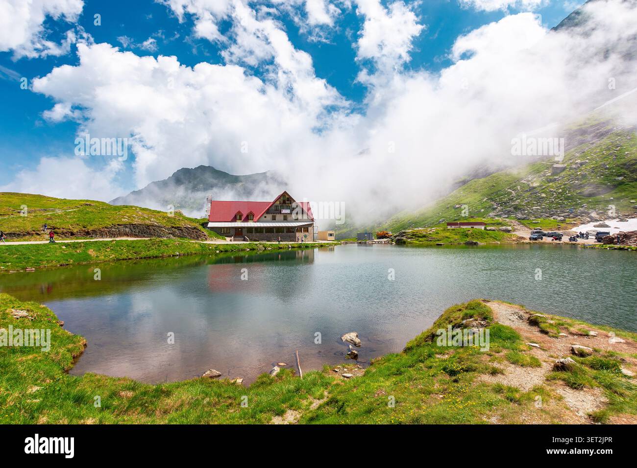 beautiful alpine scenery of fagaras mountains. balea lake in romania mountain landscape. summer weather with clouds on sky. view of rippled water near Stock Photo