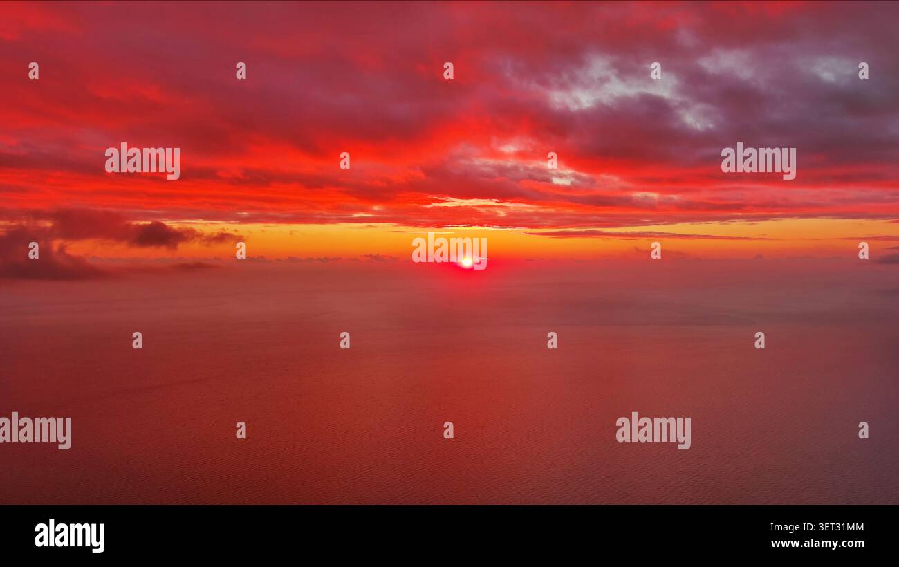 Sun setting over calm sea natural landscape Stock Photo