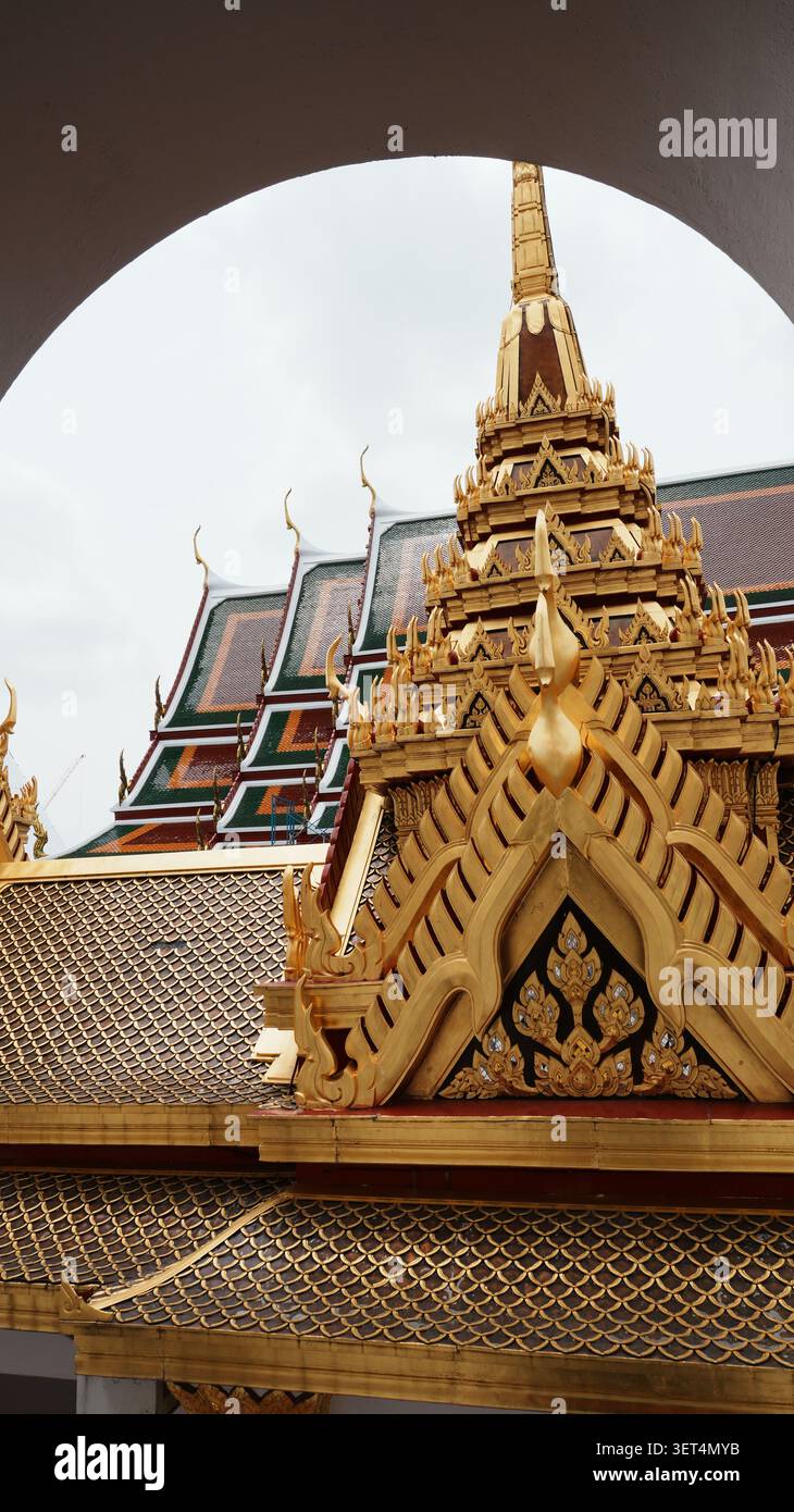 Framed View Gilded Ornate Temple Spire Seen Through Curved Arch Window Frame Stock Photo