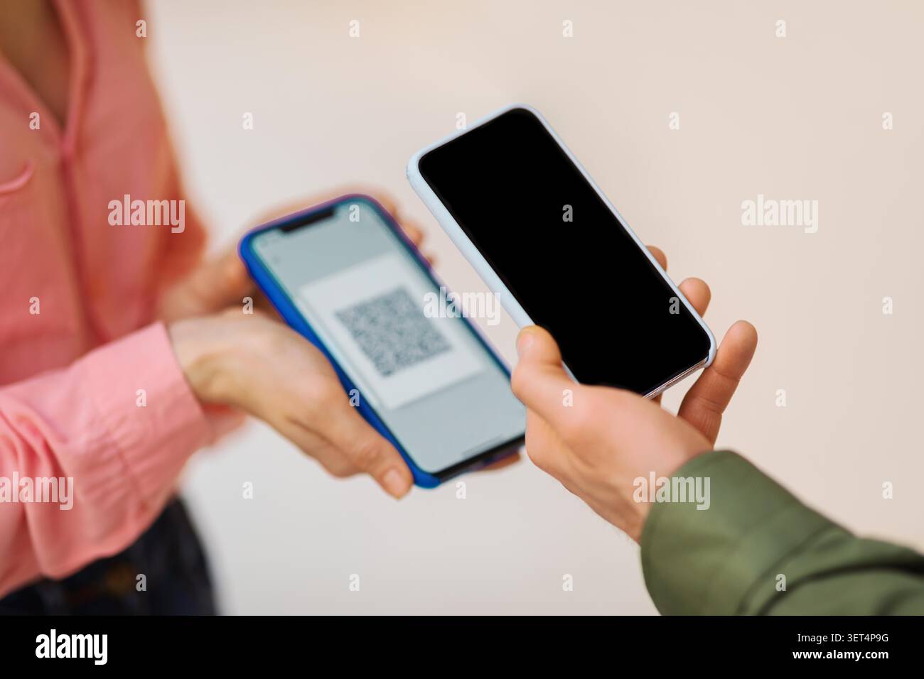 Two Individuals Exchanging Qr Code On Smartphones, Indoor Setting, Unrecognizable Stock Photo