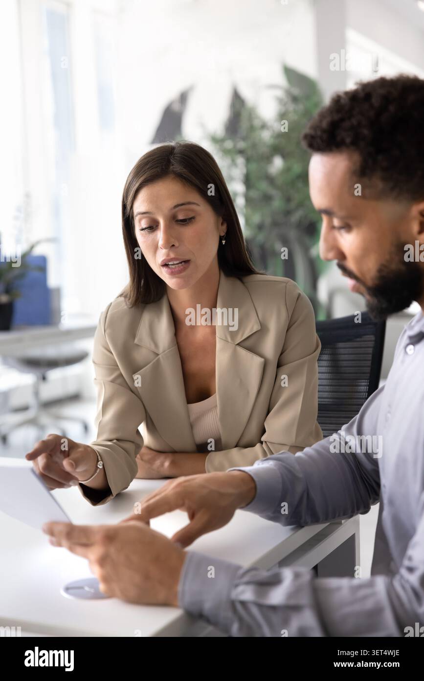 Two focused business professionals discussing or analyzing document Stock Photo