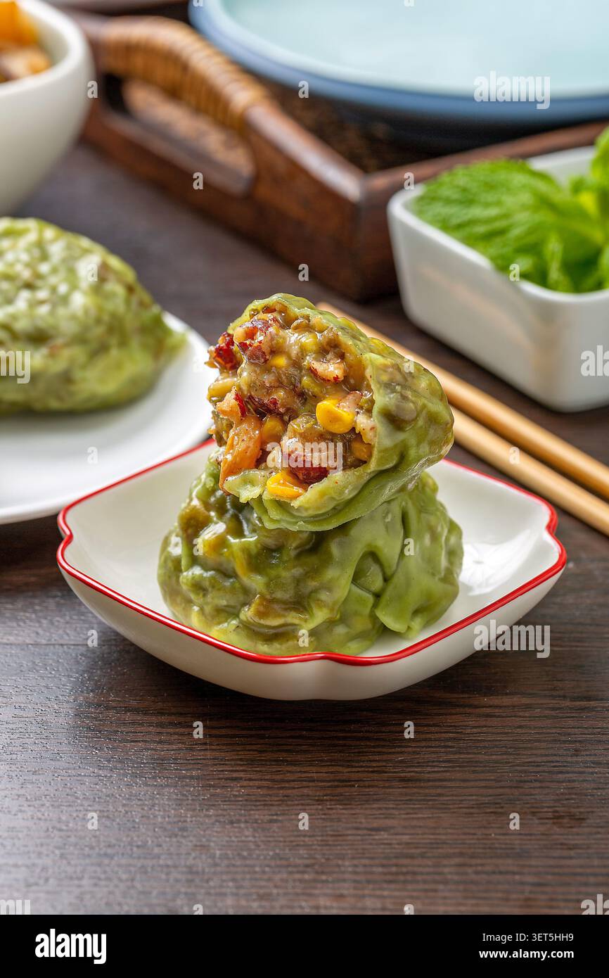 Sliced steamed sticky grain bun stacked on a small white plate with chopsticks background Stock Photo