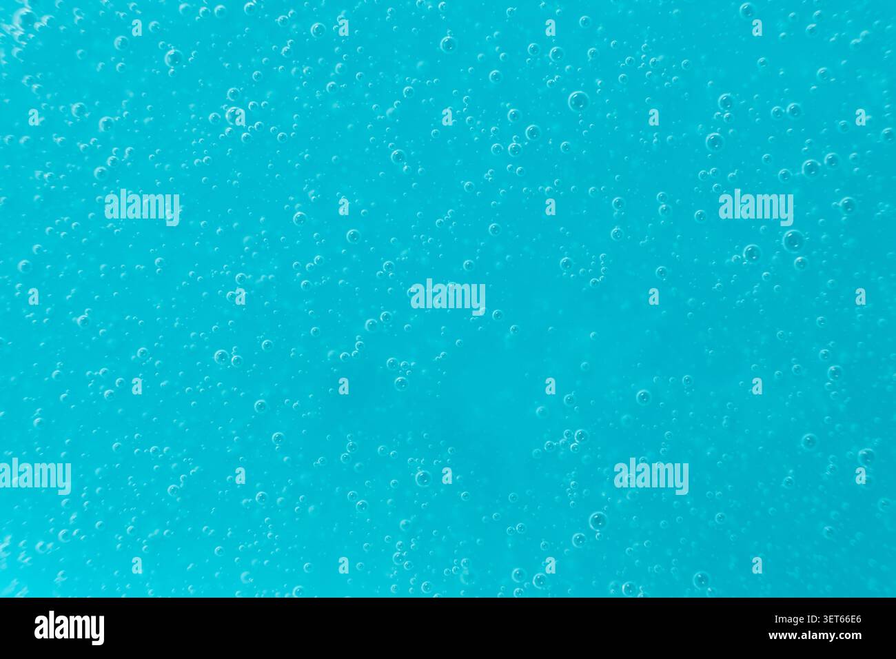 Abstract full frame background of blue liquid soap texture with micro bubbles. Stock Photo