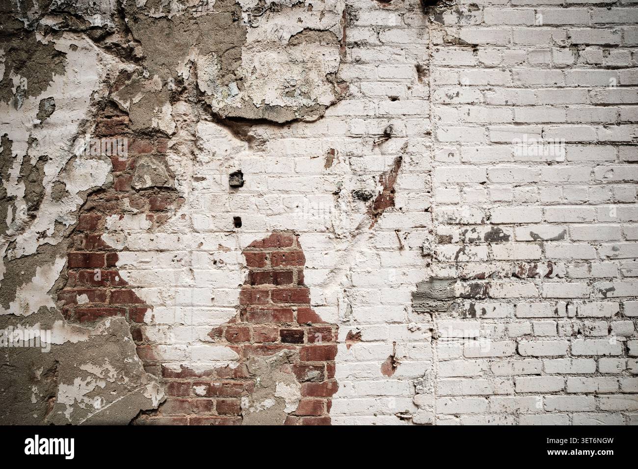 Weathered brick wall and peeling paint Stock Photo
