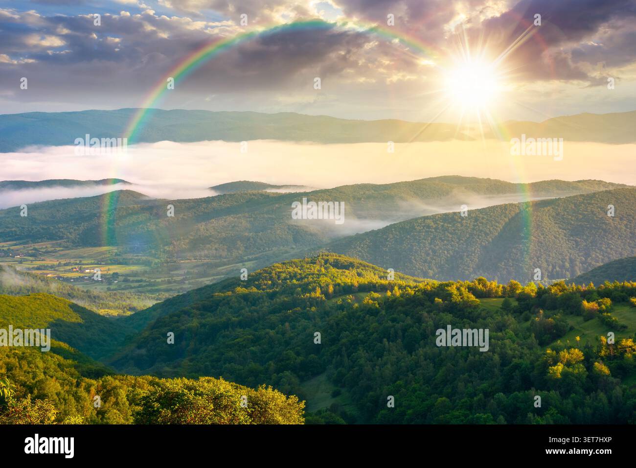foggy sunset over carpathian mountain landscape. outdoor adventure with stunning view in evening light. mountainous countryside of ukraine in summer. Stock Photo