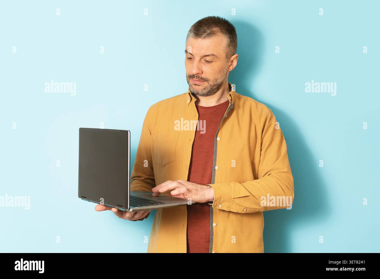 Man Using Laptop In Office, Focused On Work, Business Concept Stock Photo