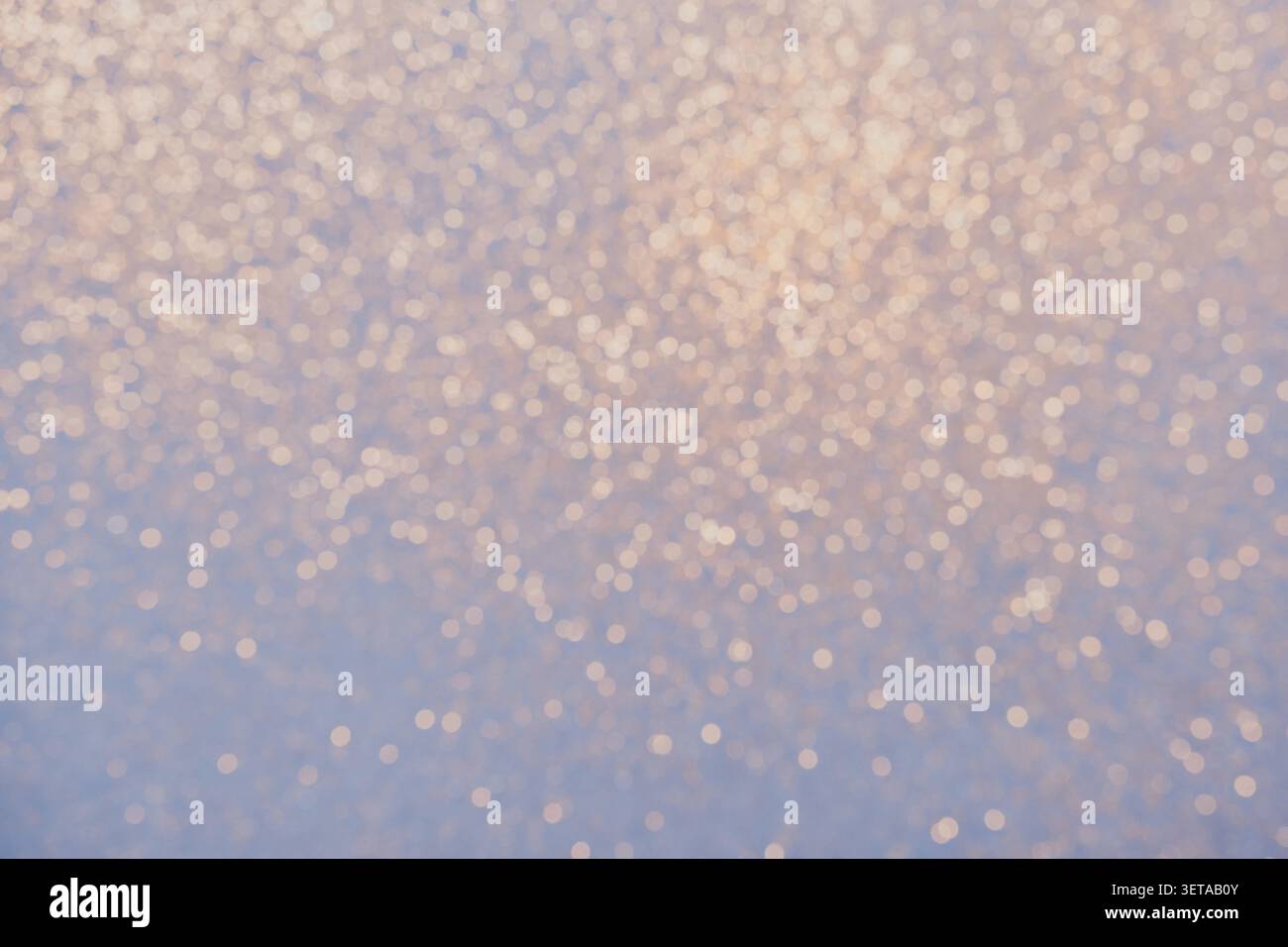 Blue background with golden glitter lights Blurred abstraction in winter Stock Photo