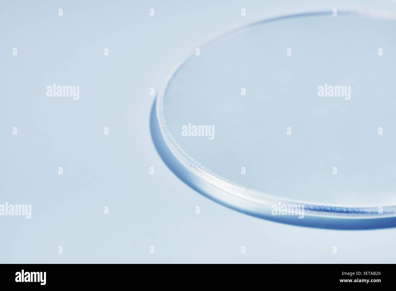 Minimalistic glass circle on light blue background with soft shadows Stock Photo