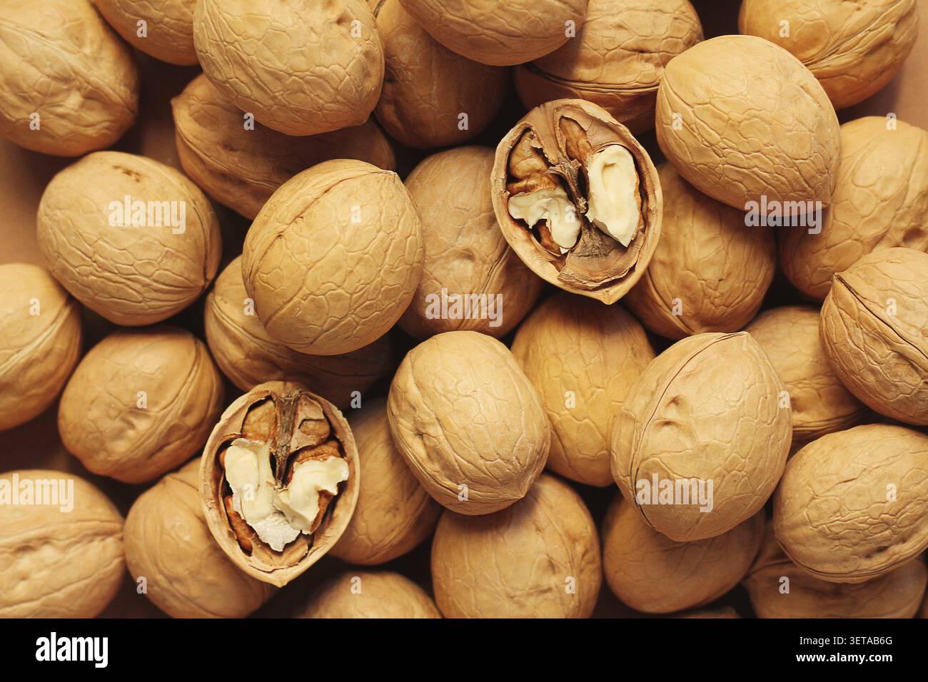 Walnuts in shell. background, close-up, view from above Stock Photo