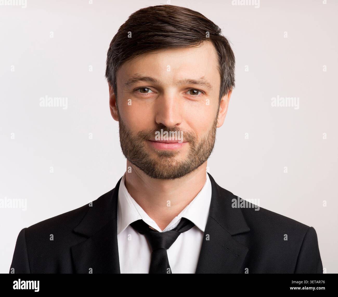 Professional Man in Formal Attire Posing Against a Neutral Background Stock Photo
