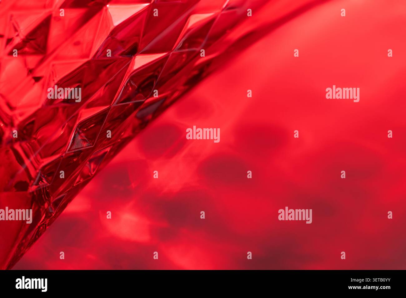 Abstract Red Glass Texture with Geometric Patterns and Intricate Light Reflections Stock Photo