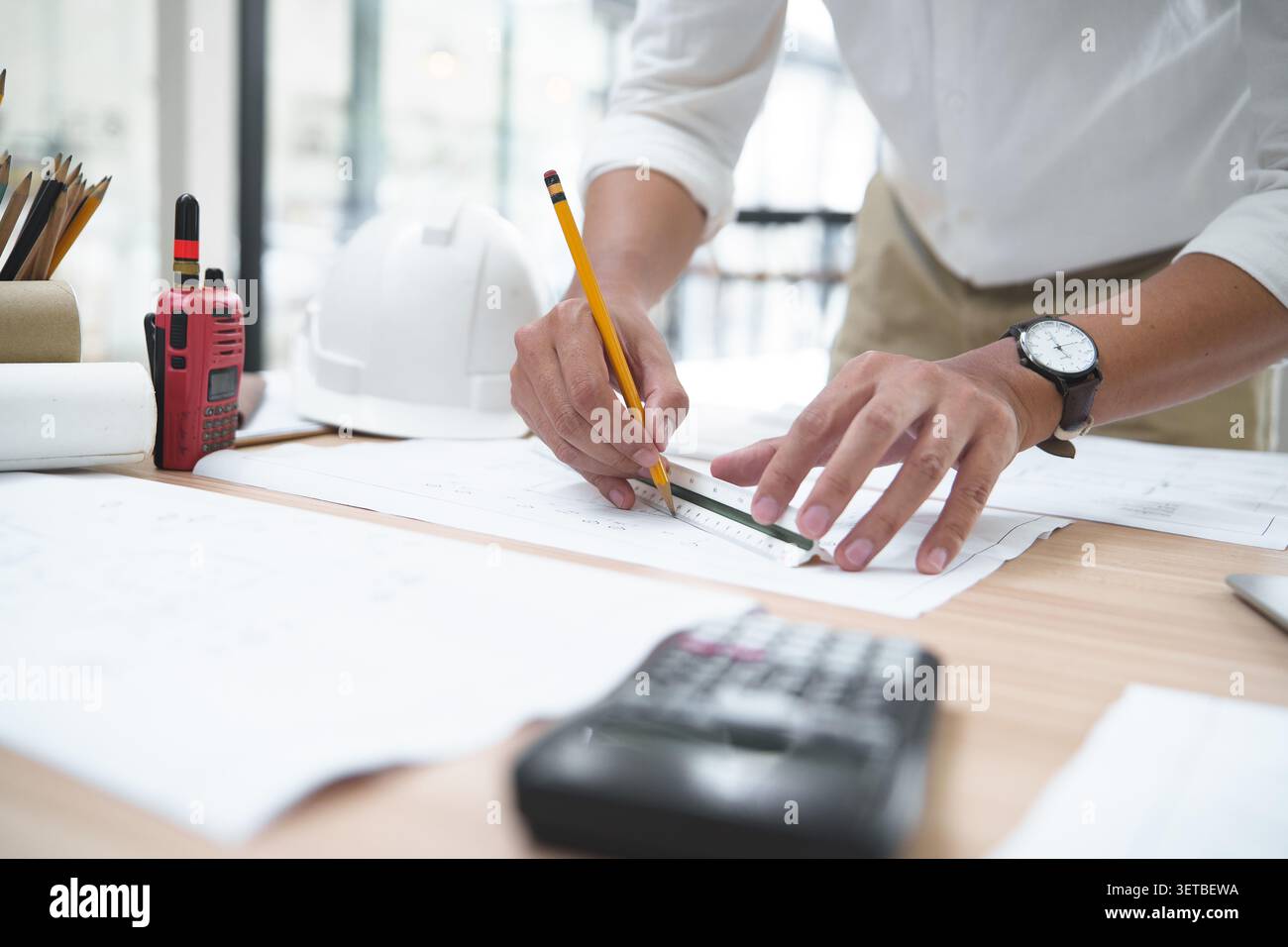 Architect or Engineer Working on Blueprints with Tools and Equip Stock Photo