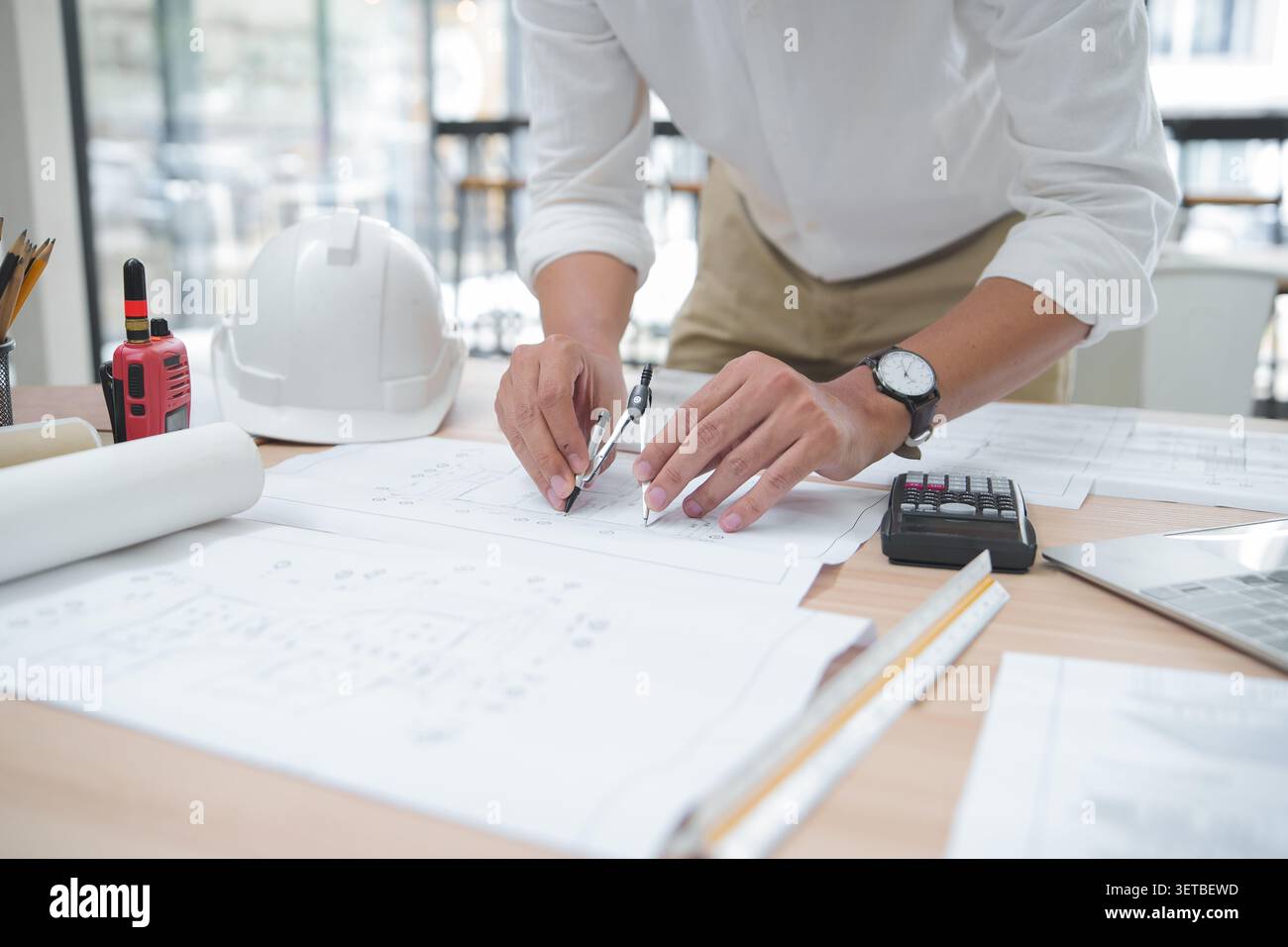 Architect or Engineer Working on Blueprint with Drawing Tools in Stock Photo