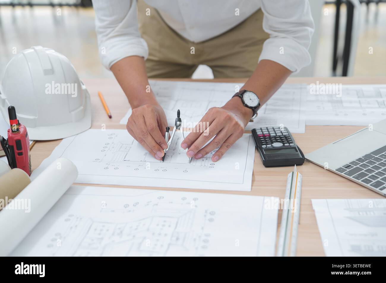 Architect or Engineer Working on Blueprint with Drawing Tools in Stock Photo