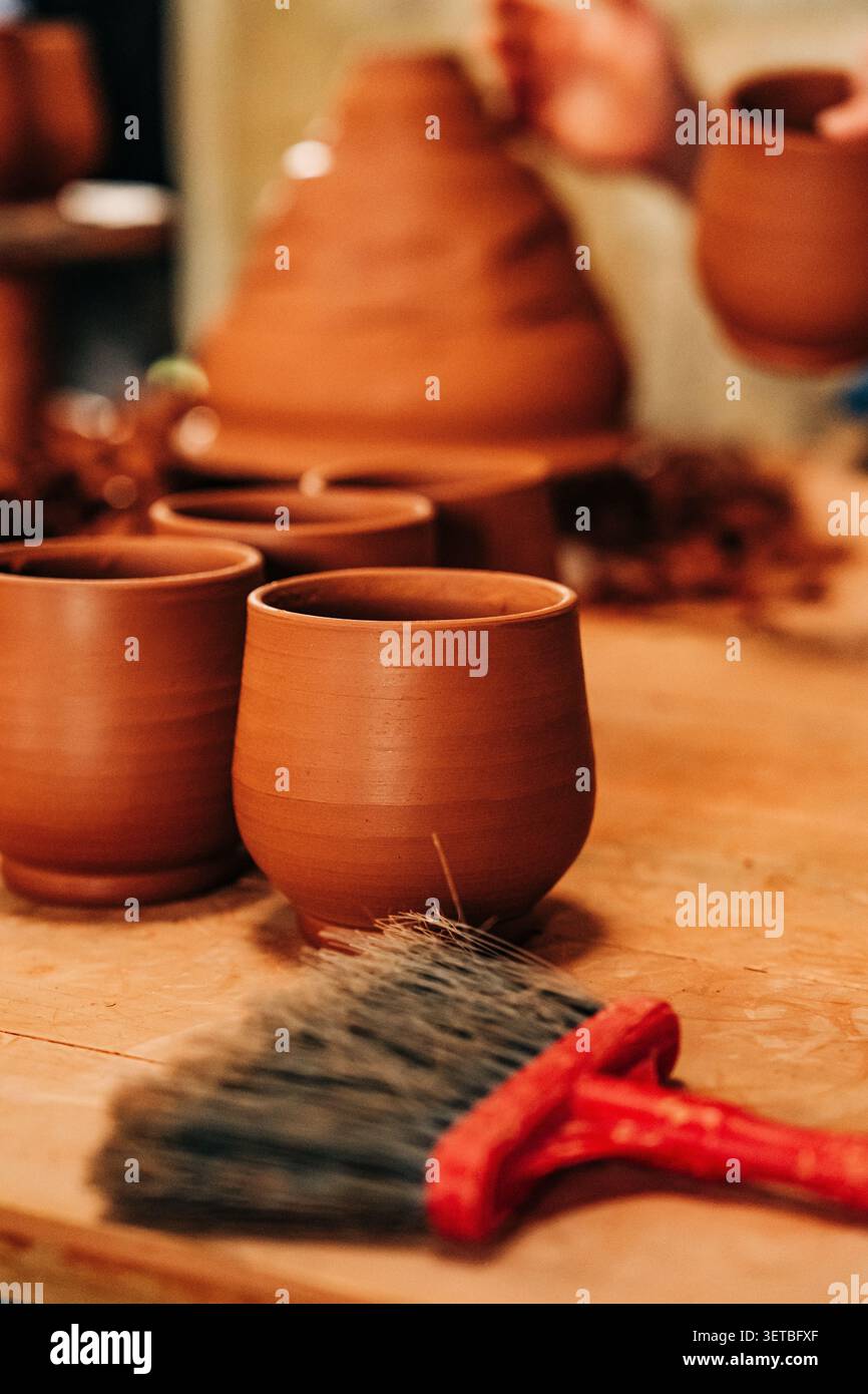 Handmade clay cups waiting in pottery workshop Stock Photo
