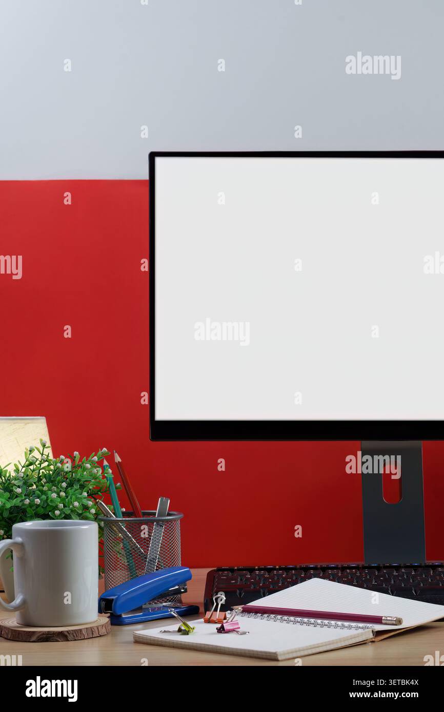 Workspace concept with blank computer screen and notebook on wooden desk Stock Photo