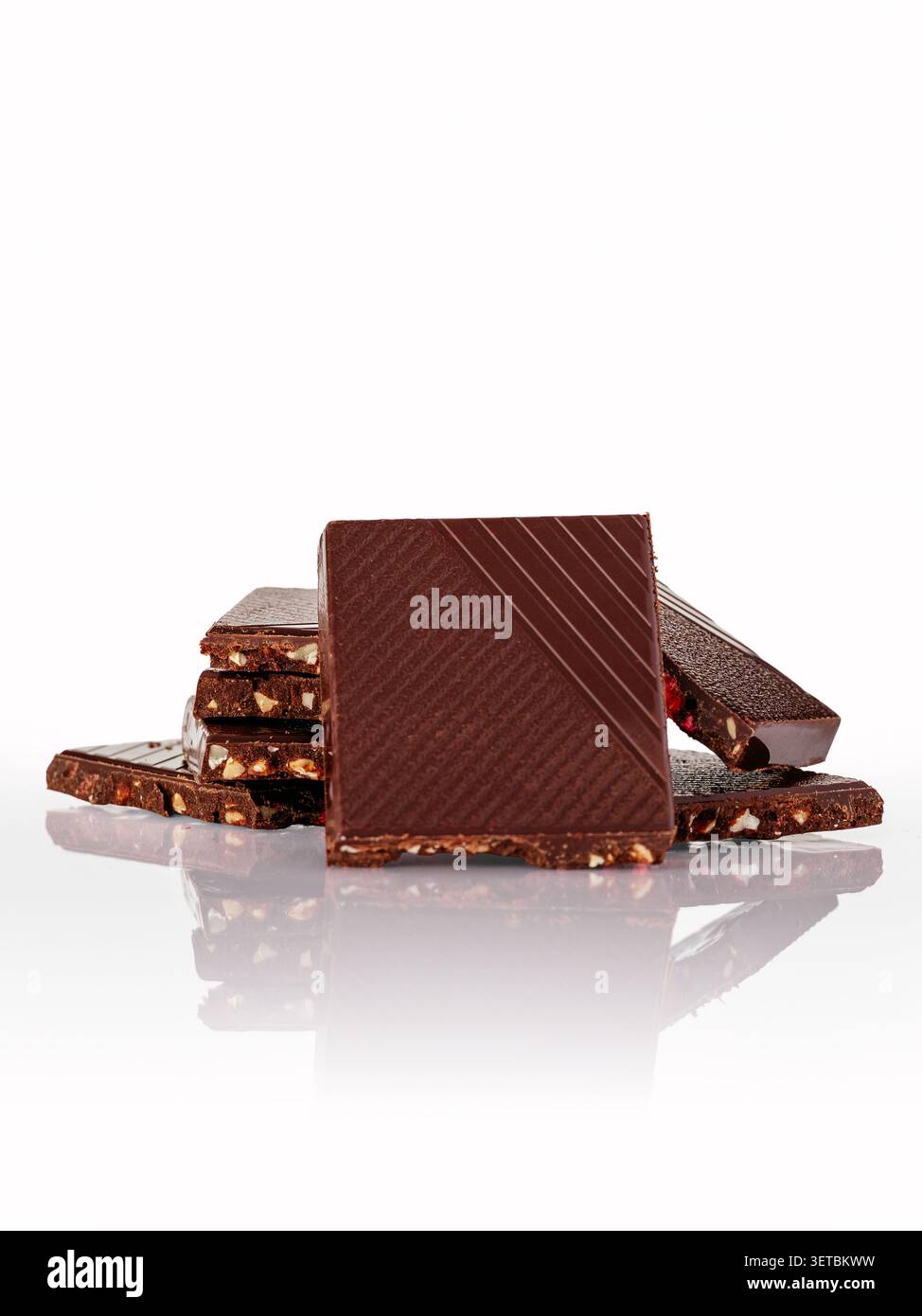 Stacked artisan dark chocolate with nuts and fruit Stock Photo