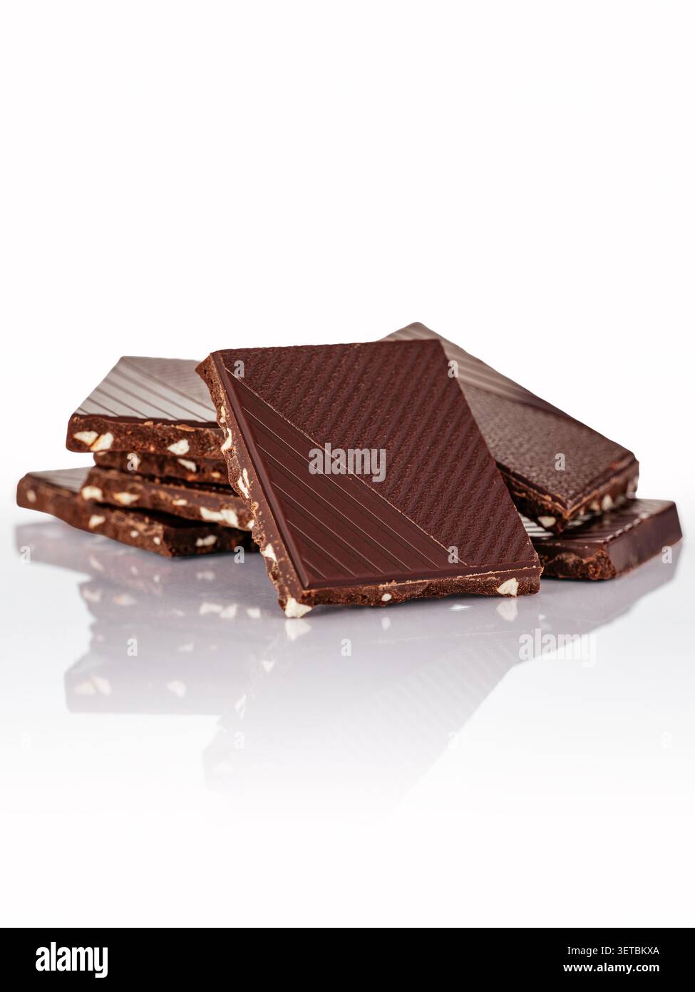 Delicious stack of dark almond chocolate squares Stock Photo