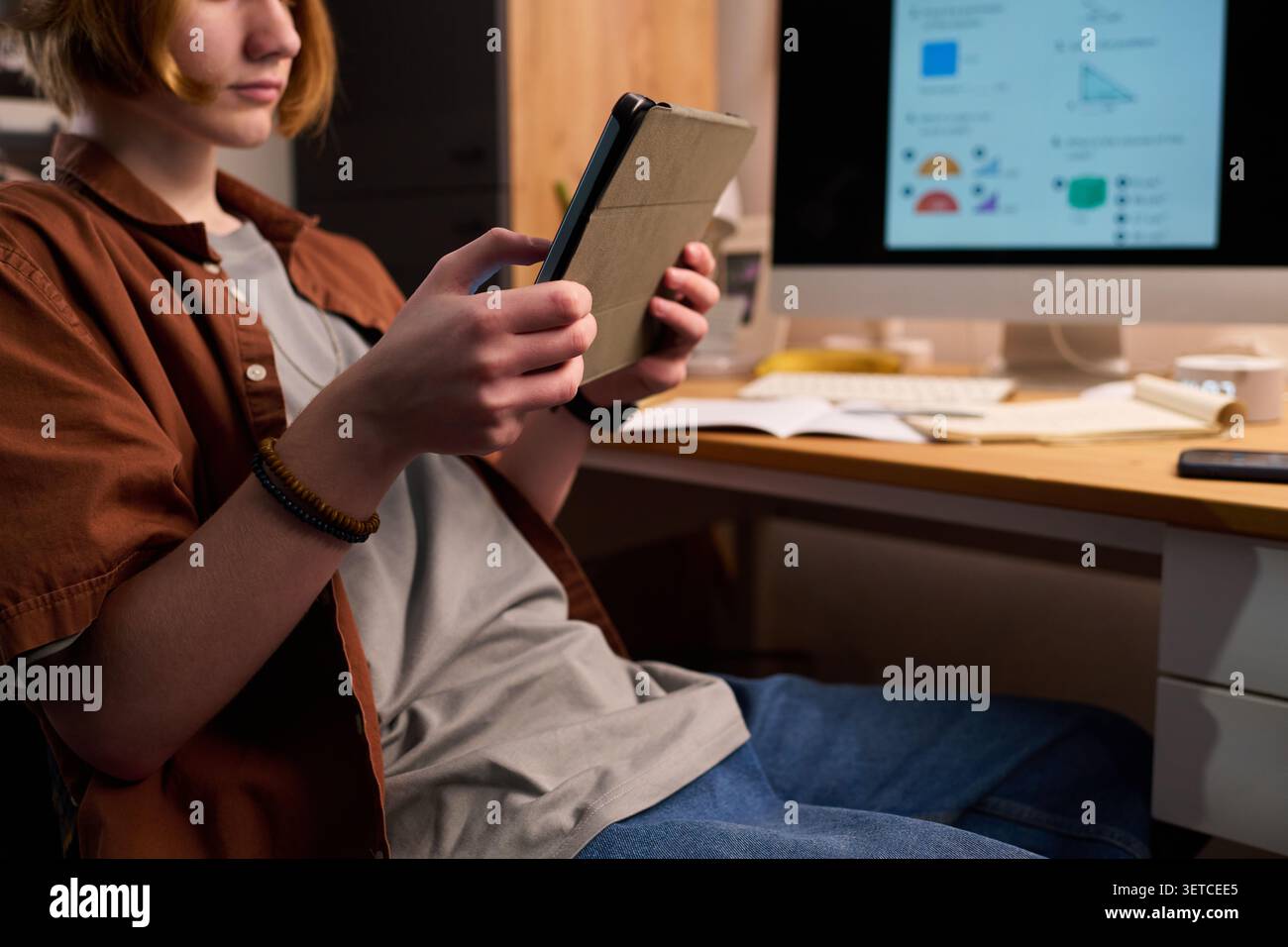 Teenager Using Tablet at Home for Online Learning Stock Photo