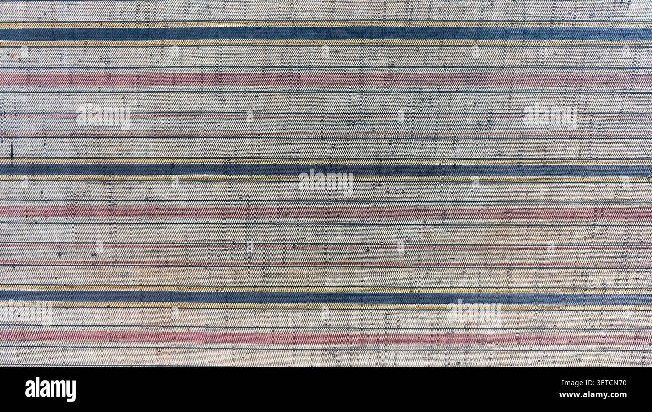 The old fabric background has a patterned, textured surface resembling cloth. Stock Photo