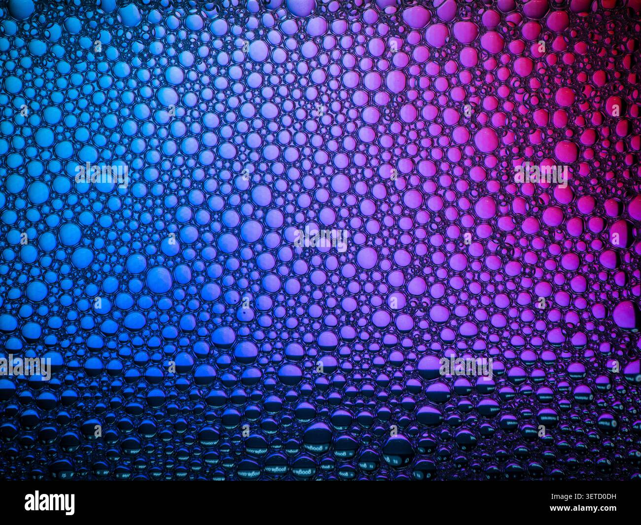 Colorful bubbles creating abstract texture on liquid surface Stock Photo