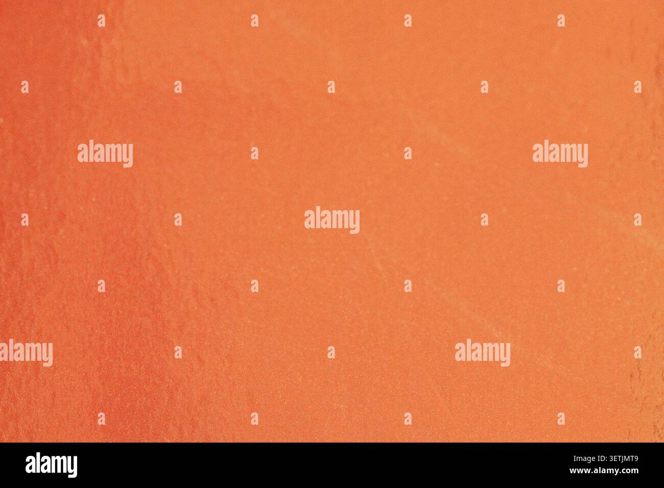 Orange metallic paper texture with fine grain and warm gradient. Stock Photo