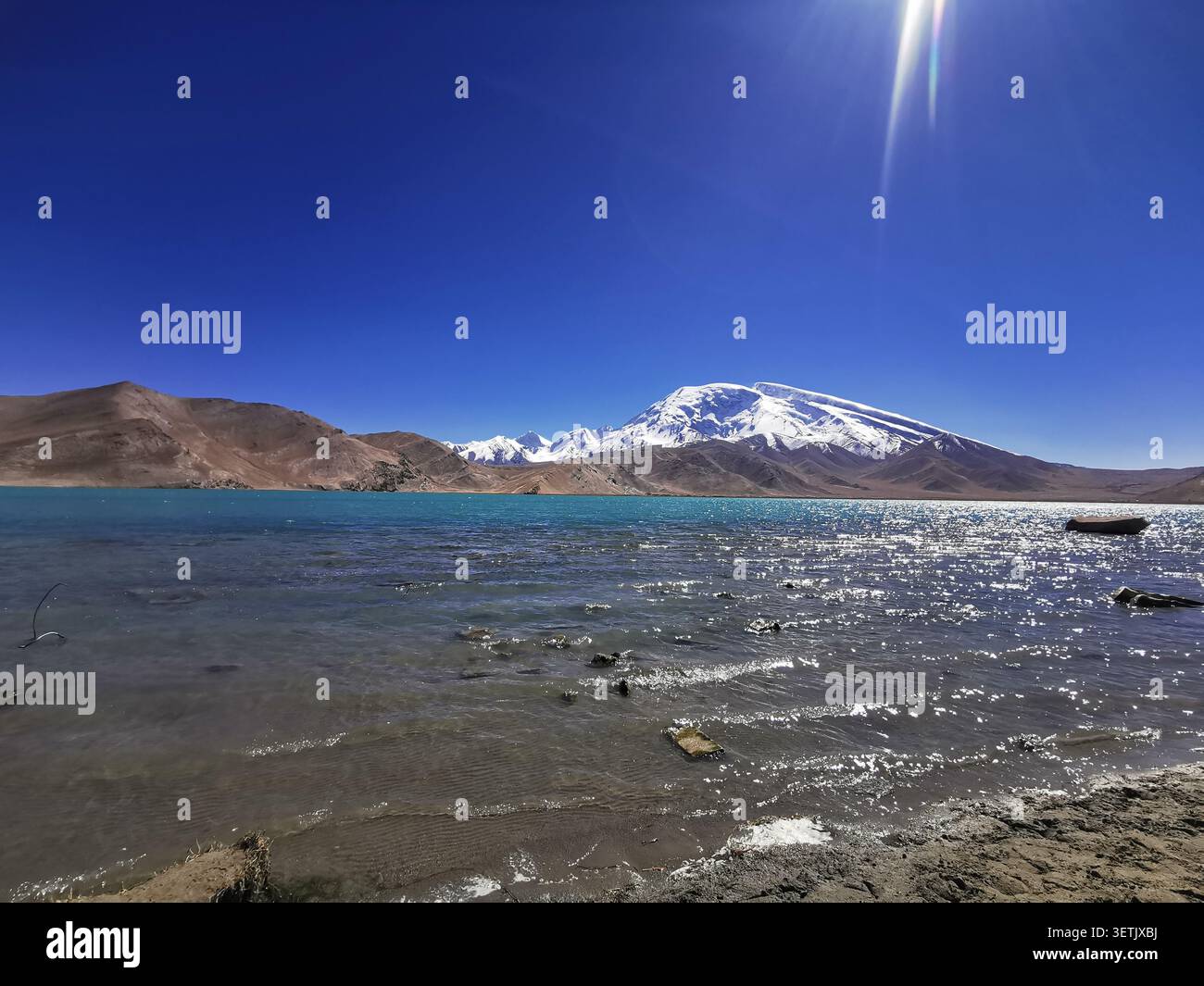 Muztagh Ata rising over the Pamir Plateau next to Lake Karakul in Xinjiang, China 巍峨傲立的慕士塔格峰冰雪峰与喀拉库勒湖壮丽风光新疆帕米尔高原 - Smartphone Captured Stock Image