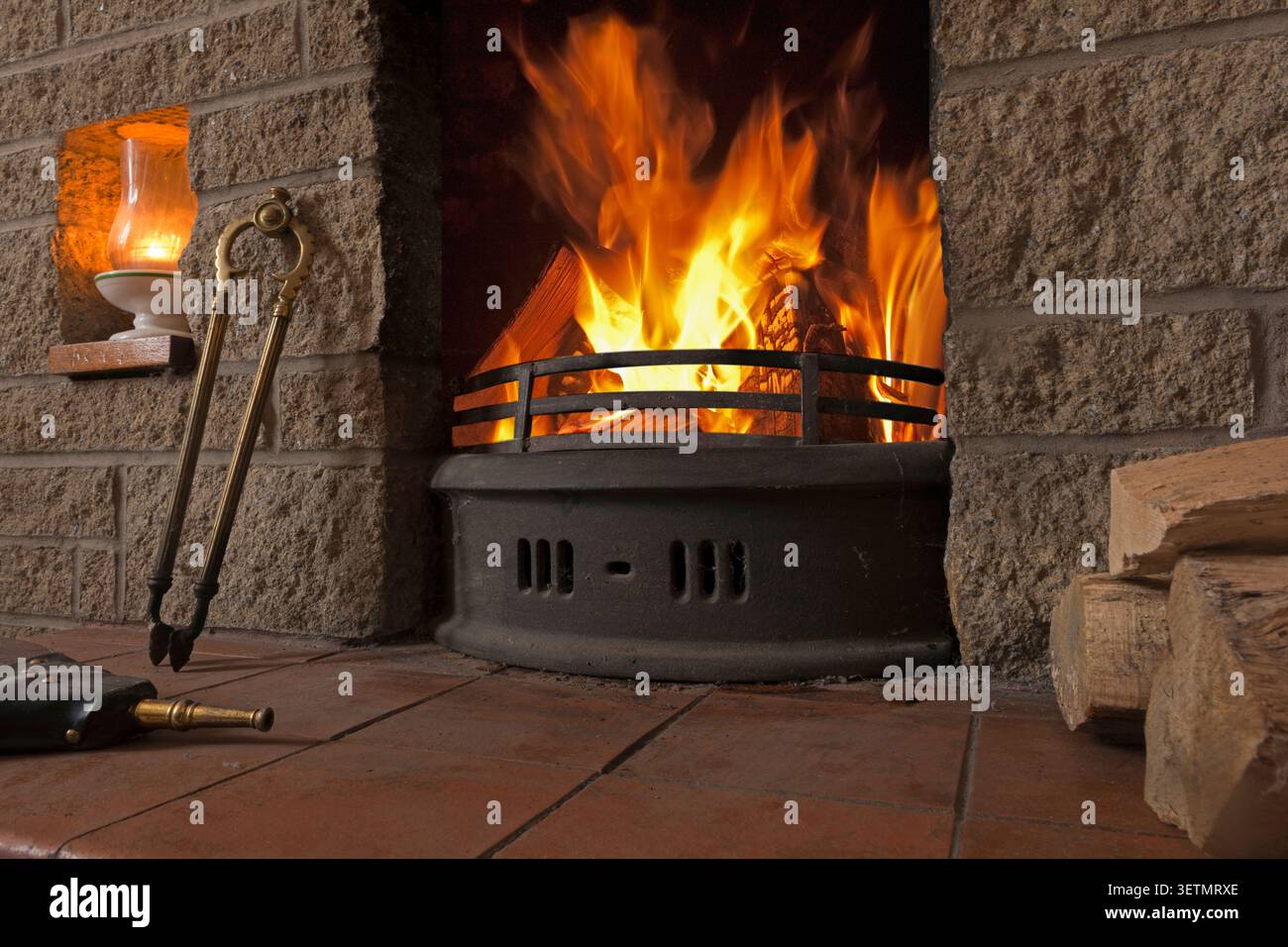 Flames and a log fire in a domestic fireplace Stock Photo