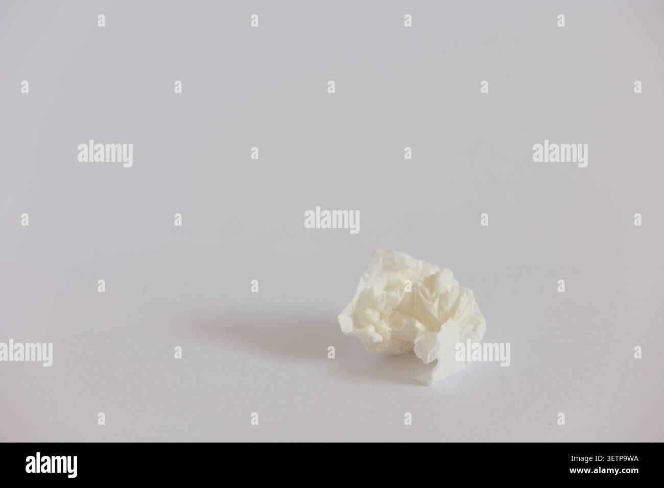 Crumpled White Tissue On Minimal Background Symbolizing Cold, Hygiene And Everyday Waste Stock Photo