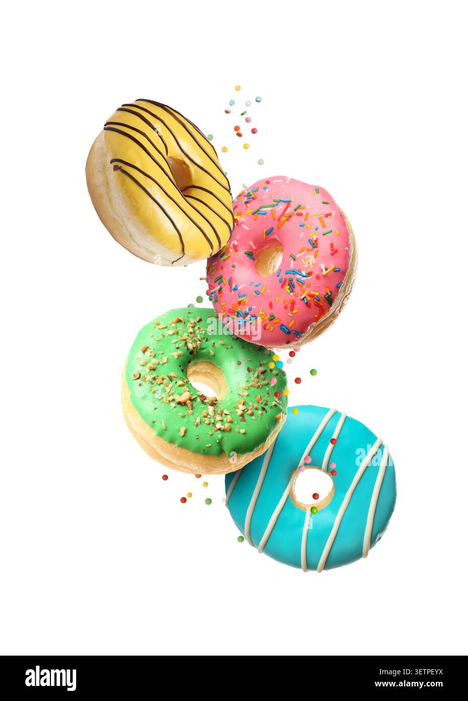 Sweet donuts and sprinkles falling on white background Stock Photo