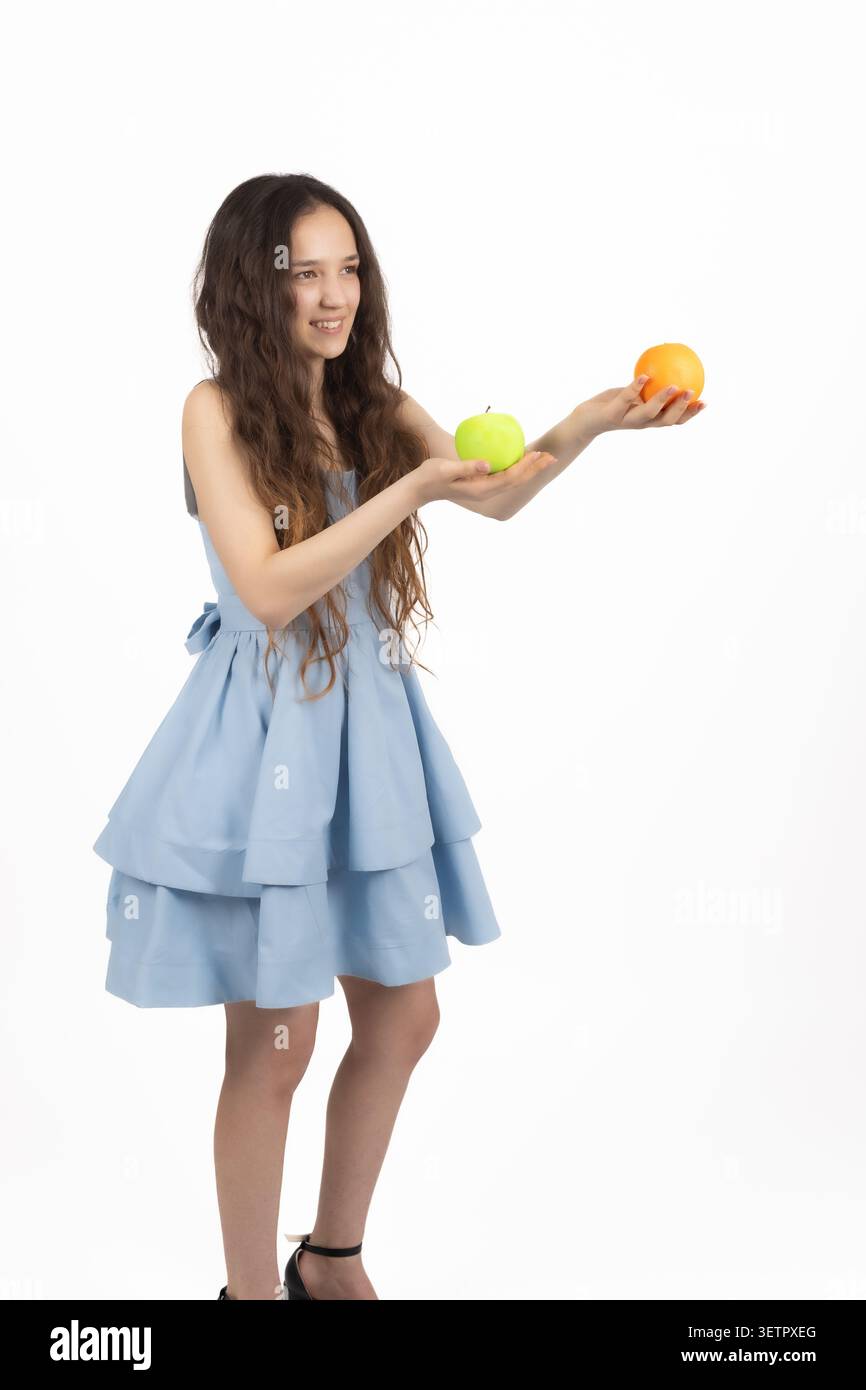 Young woman holding oranges in her hands Stock Photo