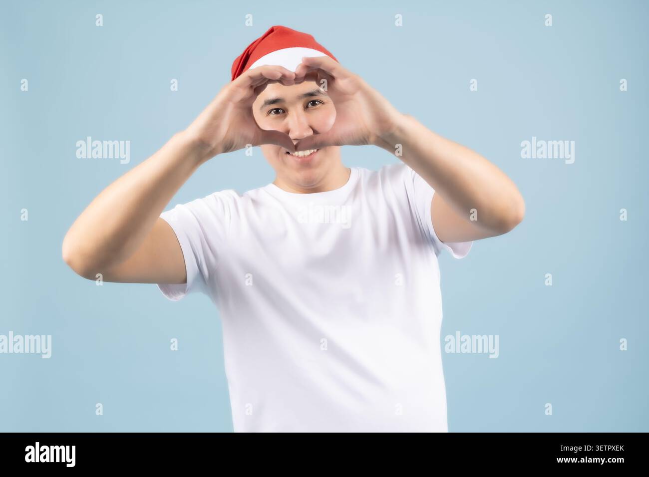Man looking through his fingers like binoculars Stock Photo