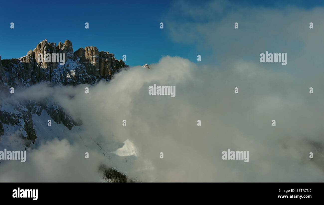 Flying through clouds between mountains Stock Photo