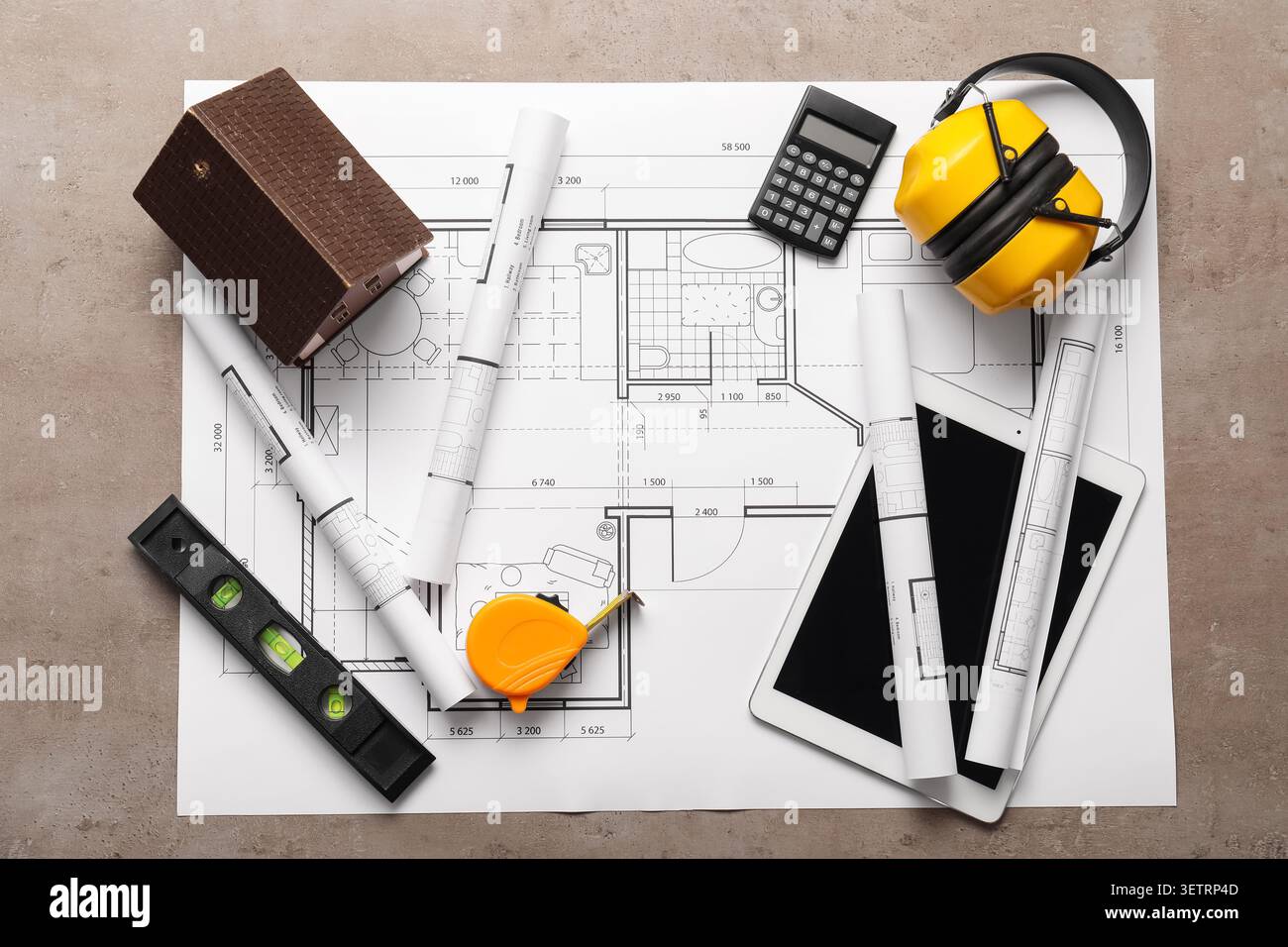 Architectural blueprints with measuring tools and model house on table Stock Photo