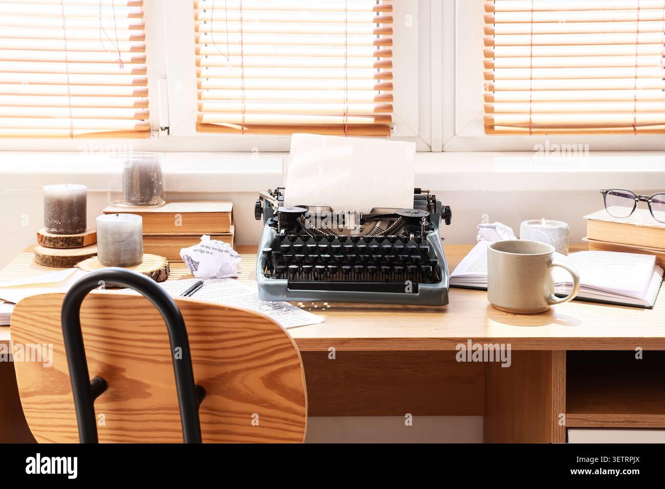 Vintage typewriter on wooden desk with writing materials Stock Photo
