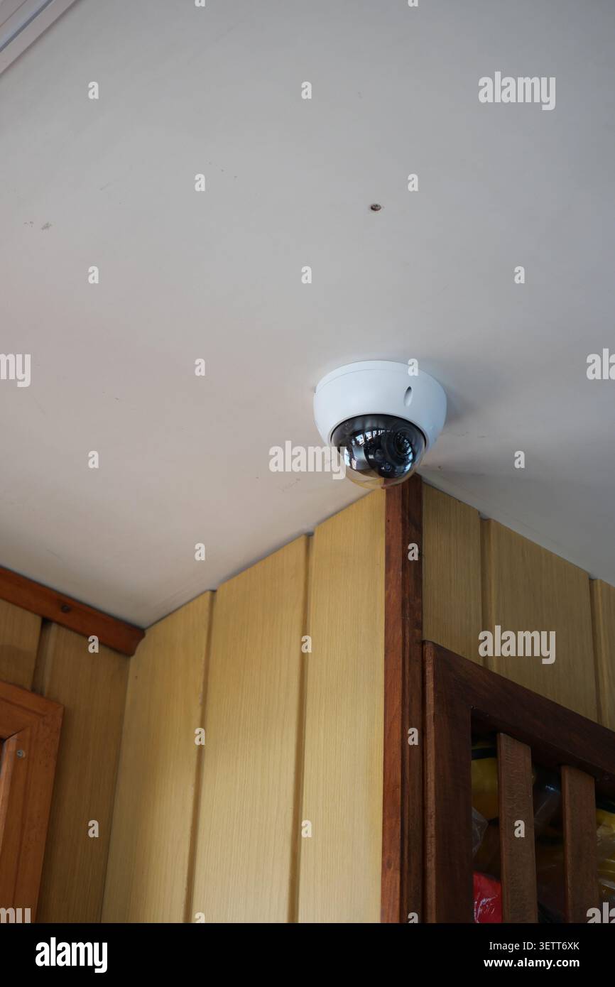 Security camera installed in building corner for safety Stock Photo