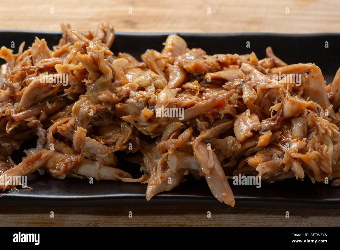 A view of a plate of crockpot BBQ chicken. Stock Photo