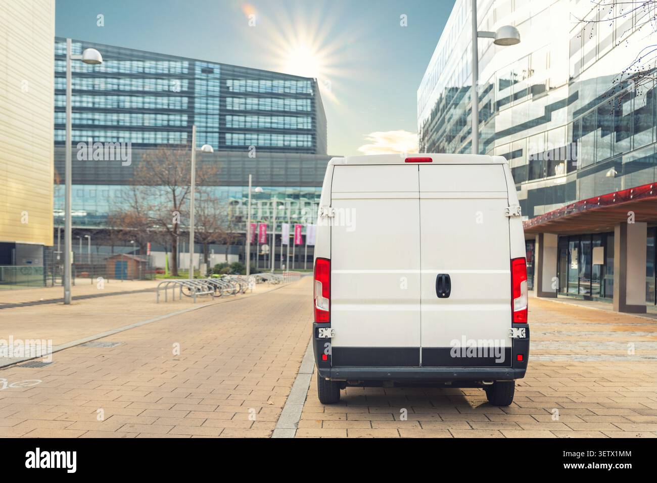 Small cargo delivery van driving in european city central district ...