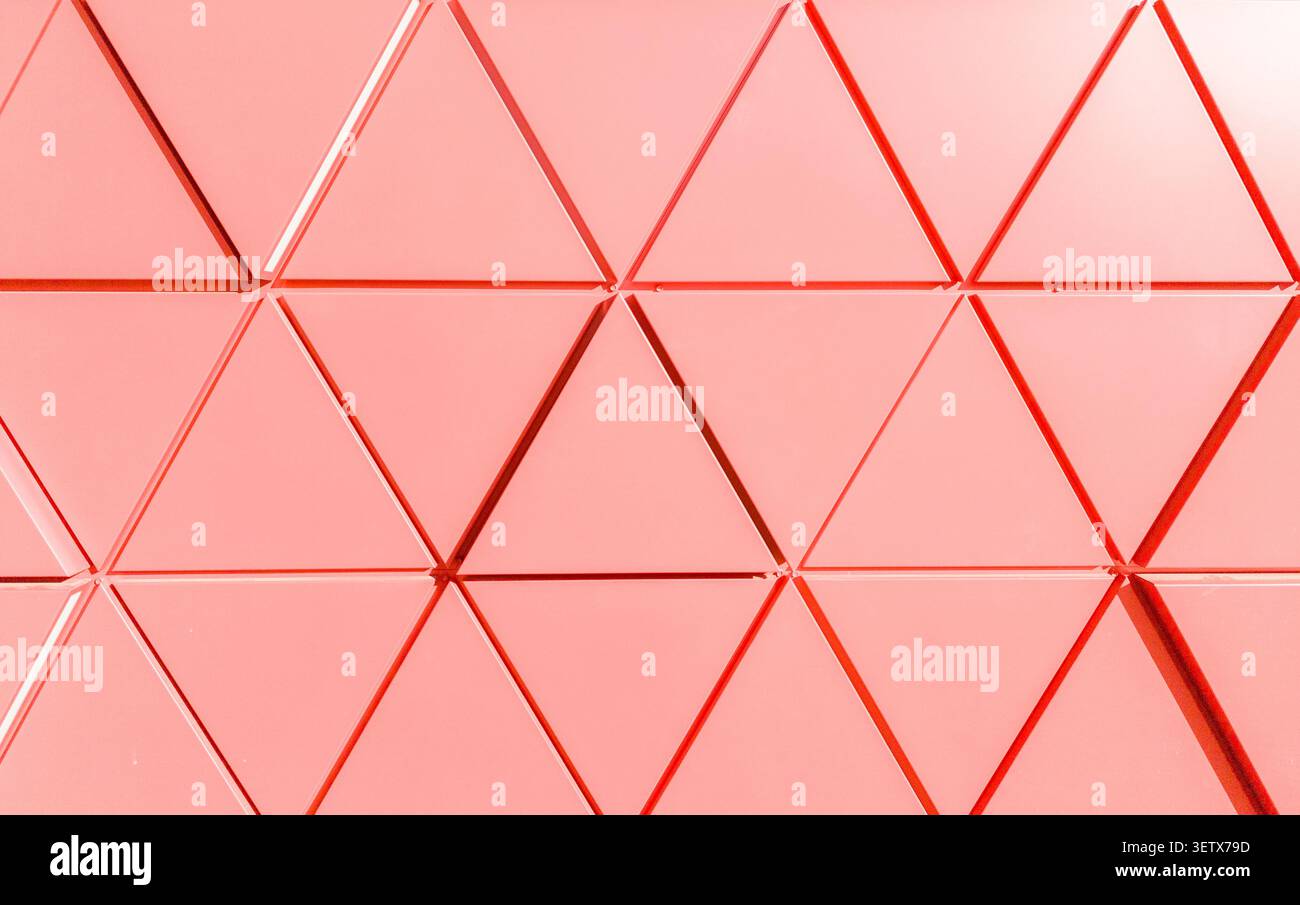 Geometric facade texture with triangular panels forming abstract pattern. Architectural surface shows repeating shapes and linear structure. Concept o Stock Photo