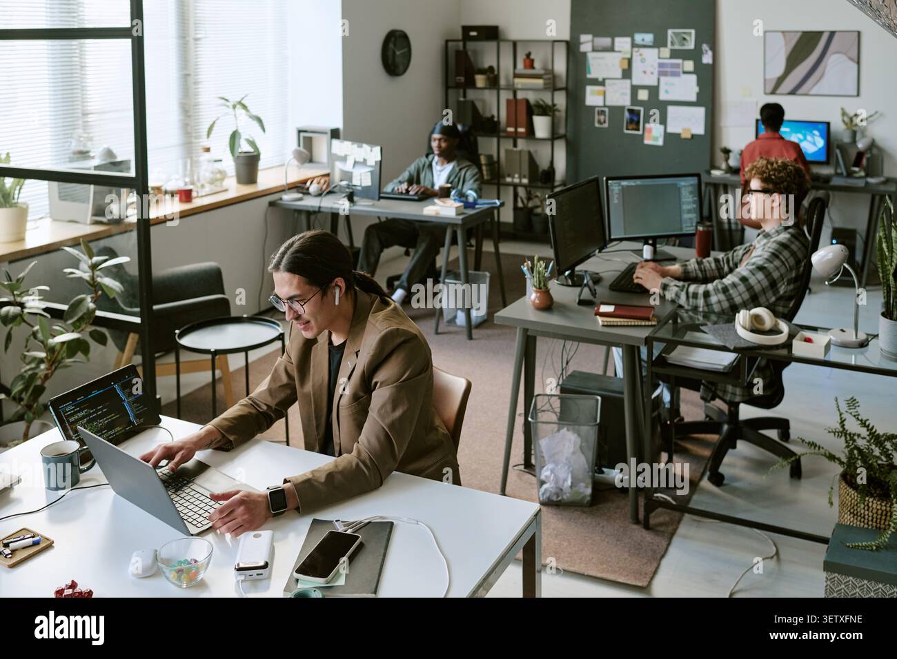 Diverse Office Team Working on Computers in Modern Creative Workspace Stock Photo