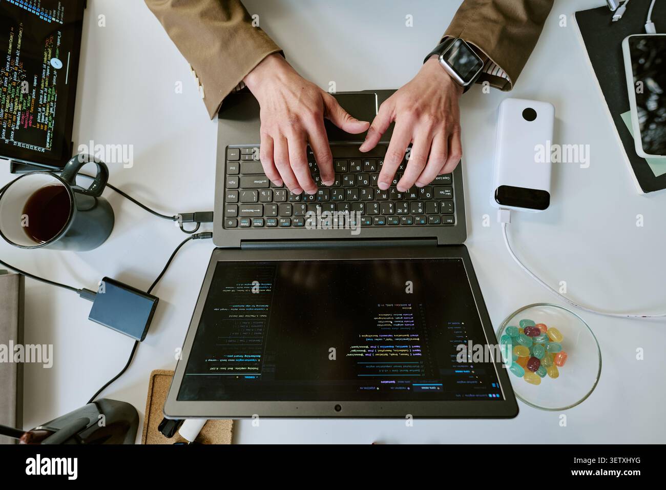 Adult Man Typing Code on Laptop for Remote Software Development Stock Photo
